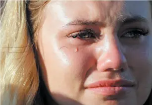  ?? AP PHOTO ?? A tear rolls down the face of Sante Fe High School junior Paige Keenan during a prayer vigil following a mass shooting at the school on Friday.