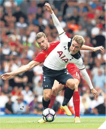  ??  ?? Spurs’ Christian Eriksen and Liverpool’s Jordan Henderson battle for possession.