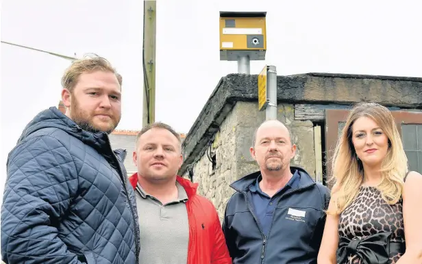  ?? PETER BOLTER ?? St Brides Major residents Jamie Griffiths, Adrian Collins, John Houston and Stacey Griffiths with the fake speed camera which they are hoping will slow traffic through the village