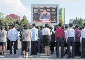  ?? Ed Jones AFP/Getty Images ?? SPECTATORS in Pyongyang listen to Kim Jong Un’s vehement response to President Trump’s U.N. address.