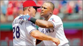  ?? AP/TONY GUTIERREZ ?? BELTRE’S GORDON, ESCOBAR career statistics. Page 5C
lead Royals to win over Red Sox. Page 4C Adrian Beltre (right) is congratula­ted by Texas Rangers Manager Jeff Banister after getting his 3,000th career hit Sunday against the Baltimore Orioles. On...