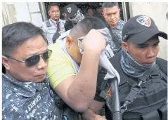 ?? PHOTOS BY AFP ?? A police officer, one of the first to be convicted in President Rodrigo Duterte’s drug war, covers his face as he is escorted after his murder sentencing.