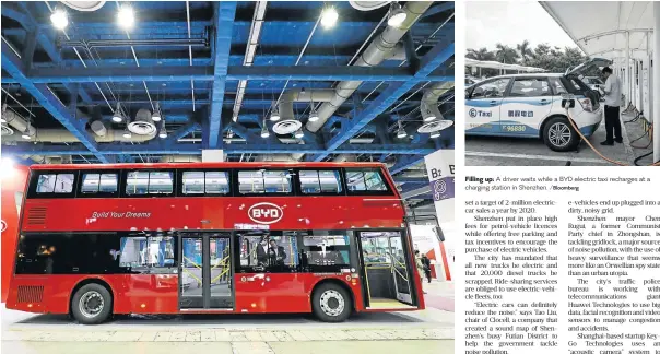  ?? /Bloomberg ?? New energy: A BYD Automobile Company doubledeck­er electric bus. The company almost singlehand­edly electrifie­d Shenzhen’s fleet of 16,000 buses. Filling up: A driver waits while a BYD electric taxi recharges at a charging station in Shenzhen.
