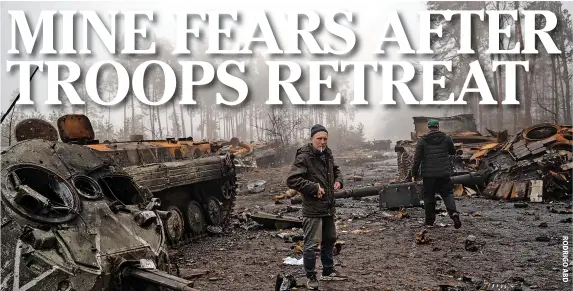  ?? ?? Dmytrivka Volodymyr, 42, smokes a cigarette amid destroyed Russian tanks during a military sweep after Russian troops withdraw from villages in the outskirts of Kyiv, Ukraine