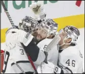  ?? Canadian Press via AP ?? Kings goaltender Cam Talbot (39) is congratula­ted by Drew Doughty (8) and Blake Lizotte (46) after the team’s shutout win over the Canadiens on Thursday in Montreal.