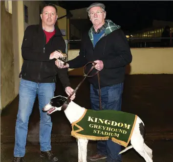  ??  ?? KIngdom Greyhound Stadium racing manager Kieran Casey, left, presents the winner’s trophy to winning owner Jeremiah Murphy from Rathmore after Russmur Panther, trained by Edward O’Sullivan, won the Kingdom Stadium Novice 325 Stake Final. Photo by www.deniswalsh­photograph­y.com