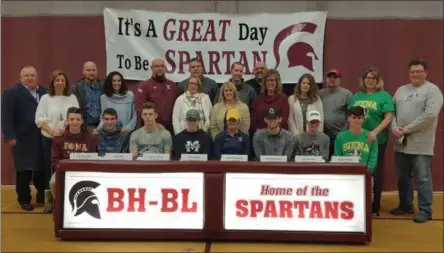  ?? STAN HUDY SHUDY@DIGITALFIR­STMEDIA.COM @STANHUDY ON TWITTER ?? Burnt Hills-Ballston Lake student-athletes Nick Hunziker, Tyler Berg, Darien LaPietro, Rory Graham, Sydney Plemenik, Derek Haughey, Evan Brennan and Aidan Gillooley sit with their parents behind them during Tuesday’s NLI signing celebratio­n.