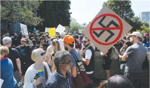  ?? (Ben Nelms/Reuters) ?? ANTI-RACISM PROTESTERS gather outside Vancouver City Hall.