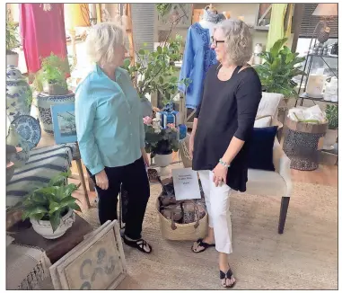  ?? / Doug Walker ?? Living & Giving Lifestyle business partners Sheree White (left) and Lisa Landry are happy with their listing among the top 50 home accessory retail shops in the nation according to Home Accents Today.