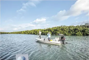  ?? PATRICK FARRELL For WLRN ?? Florida Keys fishing captain Tim Klein, above and left, uses a small device to check water salinity while looking for fish with a fly-fishing client off Islamorada .