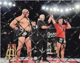  ?? JOE CSEH SPECIAL TO THE ST. CATHARINES STANDARD ?? Anthony Romero, right, is declared the winner after his MMA pro fight against Elijah Harris, left.