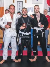  ??  ?? Trophy winners at the recent BJJ competitio­n: 1. Craig Cameron, 2. Miguel Alvarez, 3. Dean Cameron.