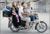  ?? PICTURE: REUTERS ?? SHORT-LIVED TRUCE: A Palestinia­n family flees on a motorcycle from their house in Khan Younis in the southern Gaza Strip yesterday. A ceasefire crumbled only hours after it began, with Israel accusing militants of violating the truce