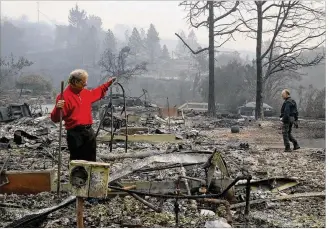  ?? JIM WILSON / NEW YORK TIMES ?? Mike Rippey pulls a stepladder from the remains of his parents’ home Tuesday in Napa, Calif., as he and his brother Chuck searched the area. Their parents, 100-year-old Charles and 98-year-old Sara Rippey, were killed as their home was destroyed by a...