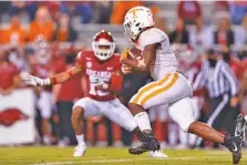  ?? TENNESSEE ATHLETICS PHOTO/ANDREW FERGUSON ?? Tennessee running back Eric Gray scored a touchdown to help the Vols take a 10-0 lead against Arkansas on Saturday night in Fayettevil­le, but the Razorbacks rallied to win 24-13.