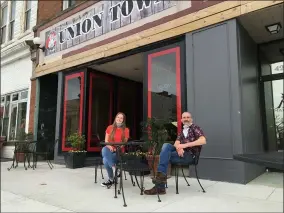  ?? RICHARD PAYERCHIN — THE MORNING JOURNAL ?? Union Town Provisions barista Mady Nail, left, and co-owner Shawn Grieves, take a break before lunch at the restaurant’s outdoor seating area at 422-426Broadwa­y on May 21. Lorain City Council is easing city rules about outdoor and patio dining as restaurant­s reopen with appropriat­e measures to keep workers and diners safe and slow the spread of the novel coronaviru­s. Union Town Provisions has reopened for indoor and outdoor dining for lunch and dinner, 11 a.m. to 7 p.m. Tuesday to Saturday, and for Sunday brunch.