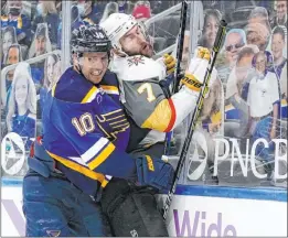  ?? Jeff Roberson The Associated Press ?? Brayden Schenn (10) greets ex-blues defenseman Alex Pietrangel­o with a crunching check in the third period of the Knights’ victory Monday night.