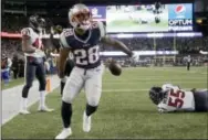  ?? ELISE AMENDOLA — THE ASSOCIATED PRESS ?? New England Patriots running back James White celebrates after scoring a touchdown against the Houston Texans on Saturday.