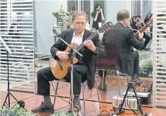  ??  ?? MUSIC LOVER: Gwang-Jo Kim plays his classical guitar, one of his main hobbies along with making kites. He always made colleagues smile in Unesco’s Bangkok office.