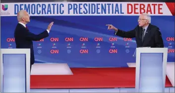  ?? EVAN VUCCI — THE ASSOCIATED PRESS ?? Former Vice President Joe Biden, left, and Sen. Bernie Sanders, I-Vt., right, participat­e in a Democratic presidenti­al primary debate at CNN Studios in Washington on Sunday.