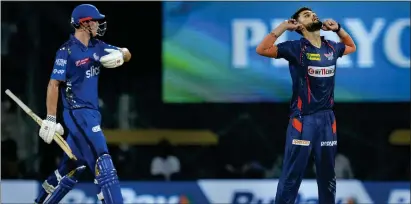  ?? — pti ?? Naveen-ul-haq cups his ears to celebrate after taking the wicket of Mumbai Indians batter Cameron Green (left).