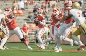  ?? Josh Morgan / Associated Press ?? Clemson quarterbac­k D. J. Uiagalelei drops back to pass during the first half against Boston College on Saturday in Clemson, S. C.