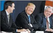  ?? EVAN VUCCI/AP ?? President Trump discusses tax policy recently with U.S. Rep. Evan Jenkins, R-W.Va., left, and West Virginia Attorney General Patrick Morrisey at a W.Va. roundtable event.