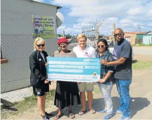  ??  ?? SPREADING JOY: Rhodes Rugby handed over a cheque for R15 000 to Home of Joy Child and Youth Care Centre last weekend. From left are team manager Elize Everton, Home of Joy founder Margaret Ngcangca, Rhodes rugby captain Jono Braans, Rhodes community...