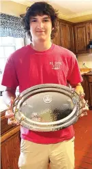  ?? Submitted photos ?? ■ LEFT: Palmer Duke pauses to pose for a photo during a day of practice.
■ ABOVE: Duke poses with his Texas State Handicap Champion trophy. Trap Handicap is where each shooter is on a specific yard line at which he has worked to achieve according to his level of skill..