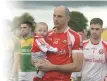  ??  ?? Dromtarrif­fe captain Seamus O’Sullivan with his son Jim and, top, leading his team out ahead of the Duhallow JAFC Final.