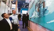  ?? Brett Coomer / Houston Chronicle ?? Exhibits draw attention at the 50th OTC. Analysts see 2018 as transition year for offshore energy.