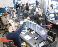  ?? ?? Engineerin­g teams celebrate at the Space Telescope Science Institute in Baltimore as the second primary mirror wing of NASA’s James Webb Space Telescope unfolds, before beginning the process of latching the mirror wing into place. – AFP photos