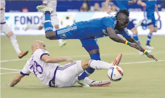  ?? PAU L C H I A S S O N / T H E C A NA D I A N P R E S S ?? The Impact’s Dominic Oduro, right, falls after being tackled by Orlando City SC’s Aurélien Collin during the home opener in Montreal on Saturday.