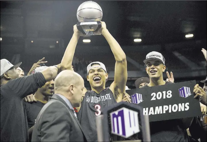  ?? Erik Verduzco Las Vegas Review-Journal @Erik_Verduzco ?? San Diego State guard Trey Kell raises his MVP trophy Saturday after the Aztecs beat New Mexico 82-75 in the Mountain West tournament final at the Thomas & Mack Center.