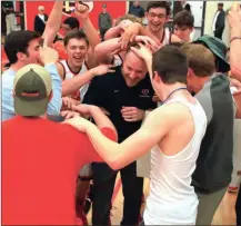  ?? LARRY GREESON / For the Calhoun Times ?? Players and students celebrate with Sonoravill­e coach Brent Mashburn after his 100th career win on Friday night.