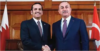  ??  ?? ANKARA: Qatari Foreign Minister Sheikh Mohammed bin Abdulrahma­n Al-Thani and his Turkish counterpar­t Mevlut Cavusoglu shake hands on the sidelines of their press conference. —KUNA