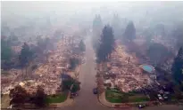  ?? Associated Press ?? This aerial image shows homes that were destroyed Monday by a wildfire in Santa Rosa, Calif. Newly homeless residents of California’s wine country took stock of their shattered lives Tuesday, a day after deadly wildfires destroyed homes and businesses.