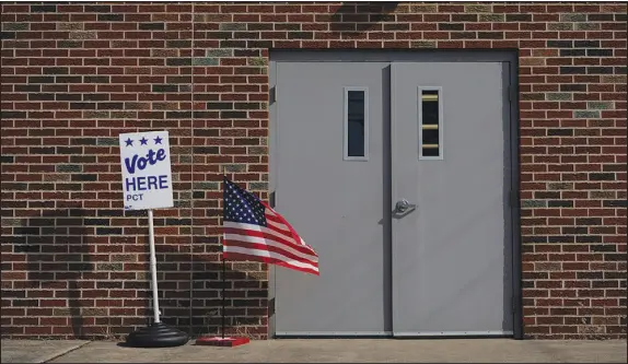  ?? CAROLYN KASTER / ASSOCIATED PRESS ?? The door of the Jeffersonv­ille Masonic Lodge polling location is marked with an American flag and a “Vote Here” sign on Election Day, Nov. 7, 2023, in Jeffersonv­ille, Ohio. The volatility surroundin­g this year’s presidenti­al contest has few modern parallels, posing profound challenges to the future of American democracy.