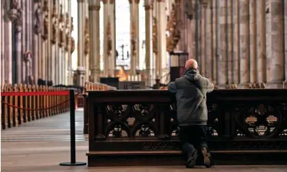  ?? Photograph: Martin Meissner/AP ?? A man prays in Cologne Cathedral. The Catholic church in Germany has 21 million members.