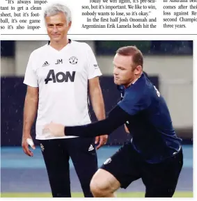  ??  ?? CLOSE WATCH: Manchester United coach Jose Mourinho and Wayne Rooney attend training. (Reuters)