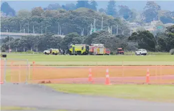  ?? Photos / Mead Norton ?? Below: Emergency services at Tauranga Airport after a light plane crashed into Tauranga Harbour.