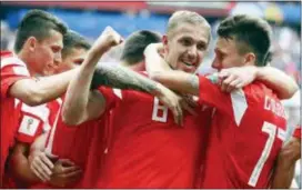  ?? MATTHIAS SCHRADER — THE ASSOCIATED PRESS ?? Russia’s Yuri Gazinsky celebrates with teammates after scoring his side’s first goal during the group A match between Russia and Saudi Arabia which opens the 2018 soccer World Cup at the Luzhniki stadium in Moscow, Russia, Thursday.