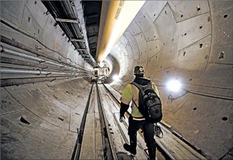  ?? TING SHEN/THE NEW YORK TIMES ?? A contractor walks down a finished portion of the Northeast Boundary Tunnel, built to mitigate sewer flooding during rainstorms, 120 feet under Washington, D.C.