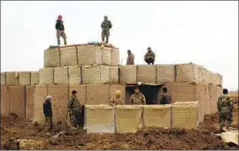  ?? AFP/Getty Images ?? AFGHAN forces guard an army outpost after a Taliban attack in Kunduz province. The U.S. said it struck back in defense of its ally — the Afghan government.