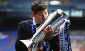  ?? Photograph: Ian MacNicol/Getty Images ?? Steven Gerrard kisses the Scottish Premier League trophy, won last season with a team that went unbeaten.