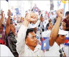  ?? PHA LINA ?? CNRP members raise their hands in support of the party’s new statute at an extraordin­ary congress last month in Phnom Penh.