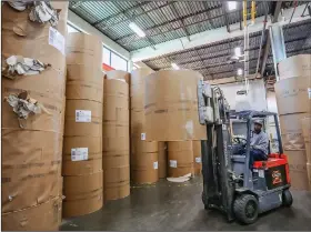  ?? Arkansas Democrat-Gazette/JOHN SYKES JR. ?? A forklift operator moves a roll of newsprint Thursday at the Arkansas Democrat-Gazette printing plant in Little Rock. The U.S. Commerce Department has levied tariffs of up to 30 percent on newsprint manufactur­ed in Canada.