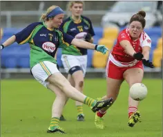  ??  ?? St Nicholas’s Jill Fadian blasts to the net for a goal despite the efforts of Tinahely’s Áine O’Keeffe.