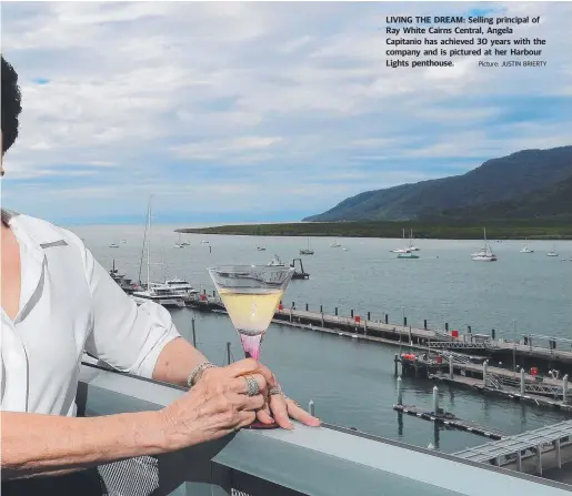  ??  ?? LIVING THE DREAM: Selling principal of Ray White Cairns Central, Angela Capitanio has achieved 30 years with the company and is pictured at her Harbour Lights penthouse. Picture: JUSTIN BRIERTY