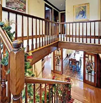  ?? Teresa Huhn/Betsy Wotherspoo­n & Team ?? Clockwise from top left: The back patio features an outdoor kitchen. The living room has an arched wood-burning fireplace. The view from the staircase landing.